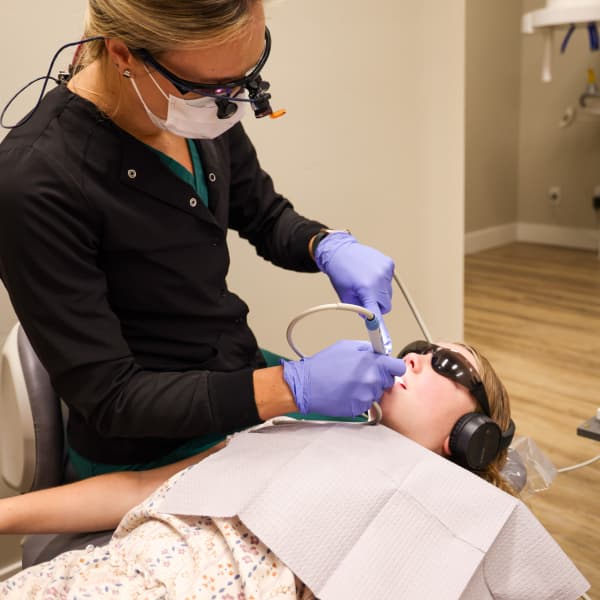 A young person receiving dental treatment